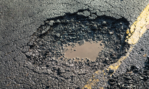 a pothole in a tarmac road